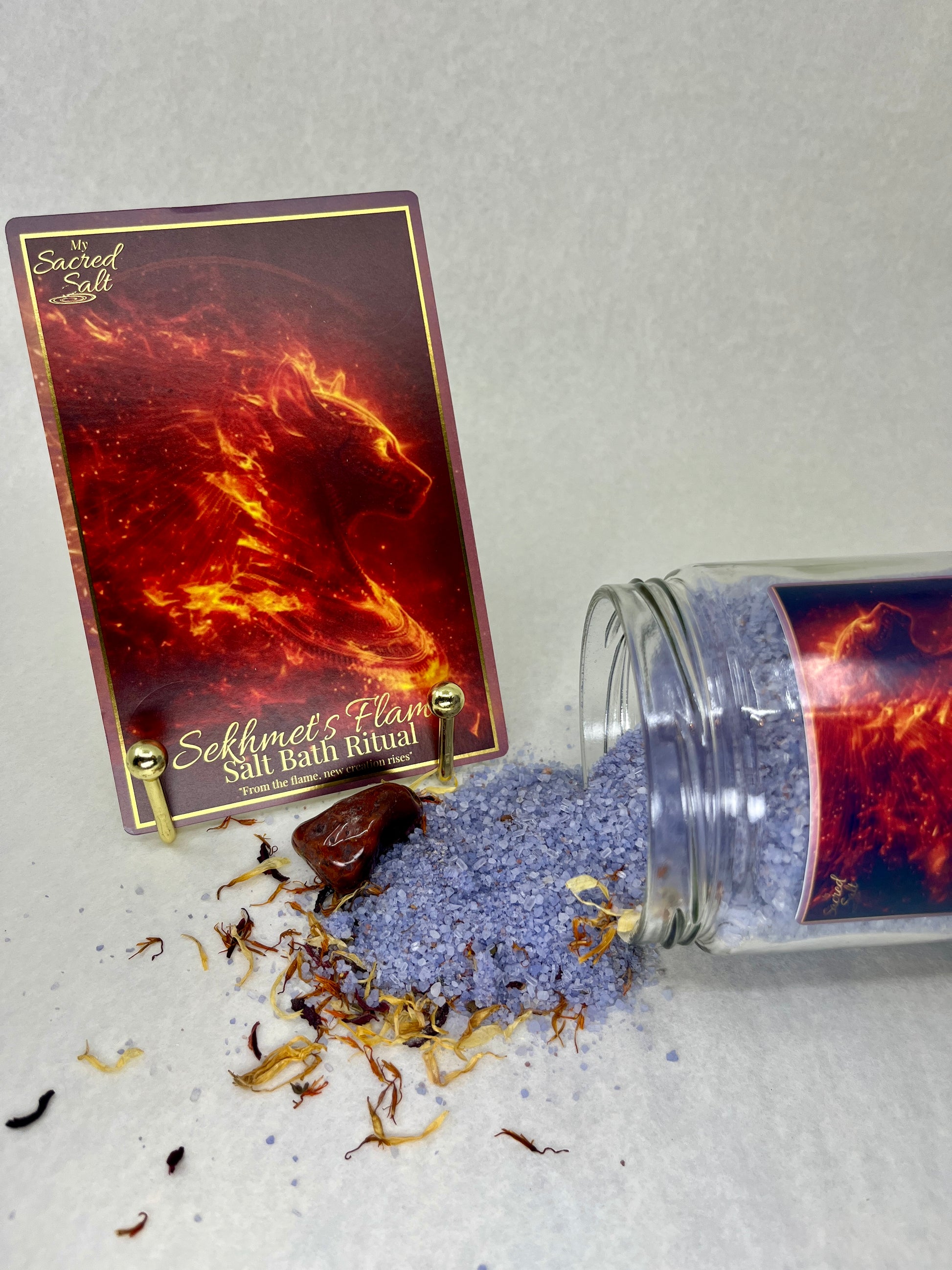 Salt bath ritual product with packaging labeled 'Sekhmet's Flame' on a light gray background.