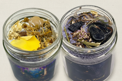 Two clear jars from the Protected & Abundant Salt Bath collection with dried herbs and flowers on a white background