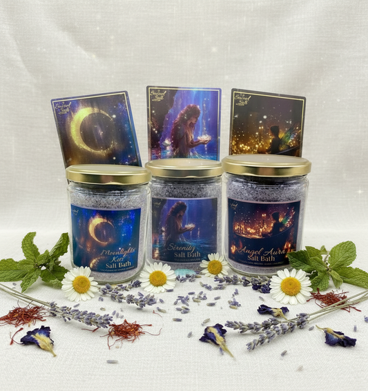 Three jars of salt bath products from the Wash it Away Salt Bath Collection with decorative labels and botanicals on a white background