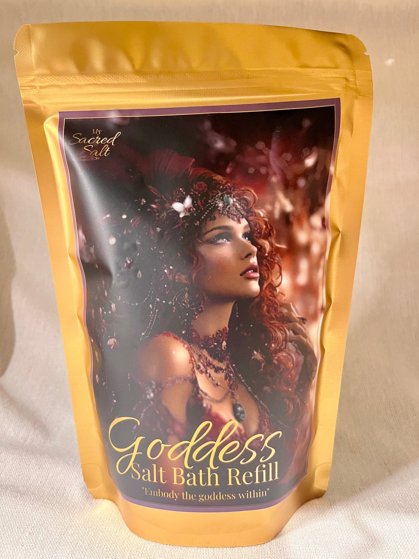 Goddess Salt Bath Refill packaging with a woman's face on a scarlet background