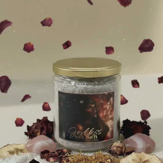 Jar of Goddess Salt Bath with decorative elements on a textured surface