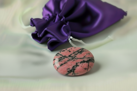 Pink stone with black marbling on a white background