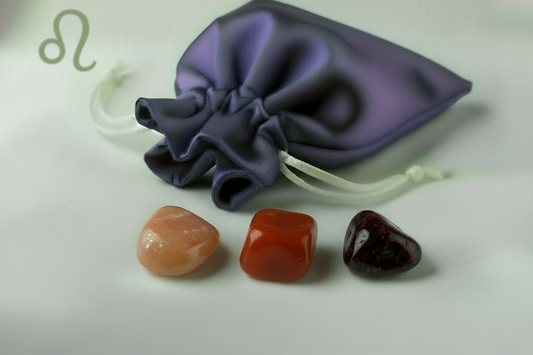 Purple drawstring bag with three colorful stones on a white background