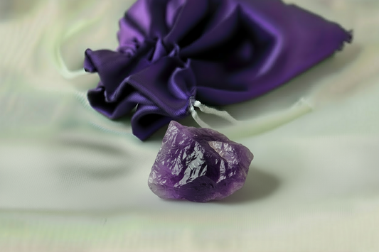 Purple crystal and bag on a light background