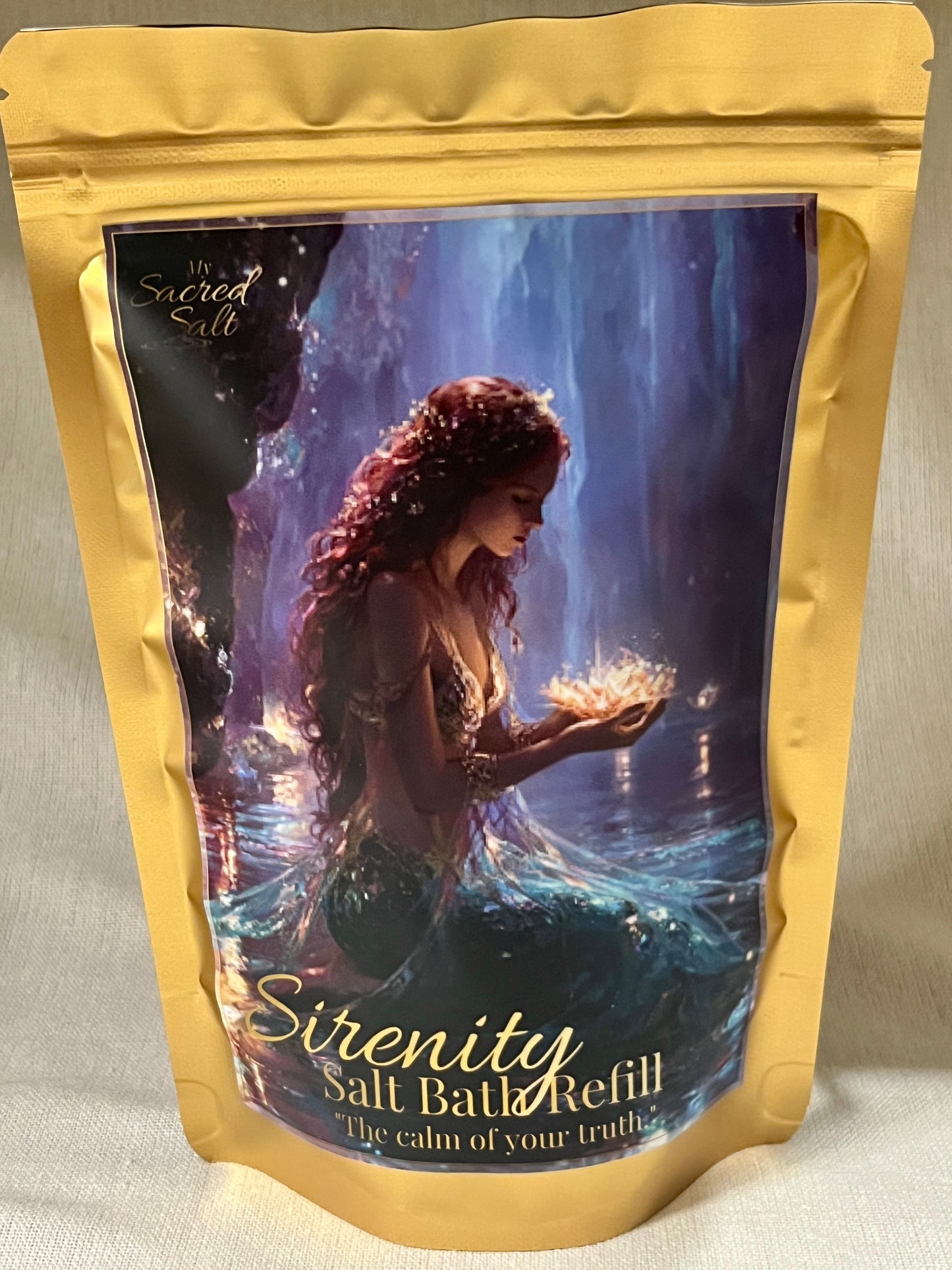 Salt bath refill package with mermaid illustration on a blue background