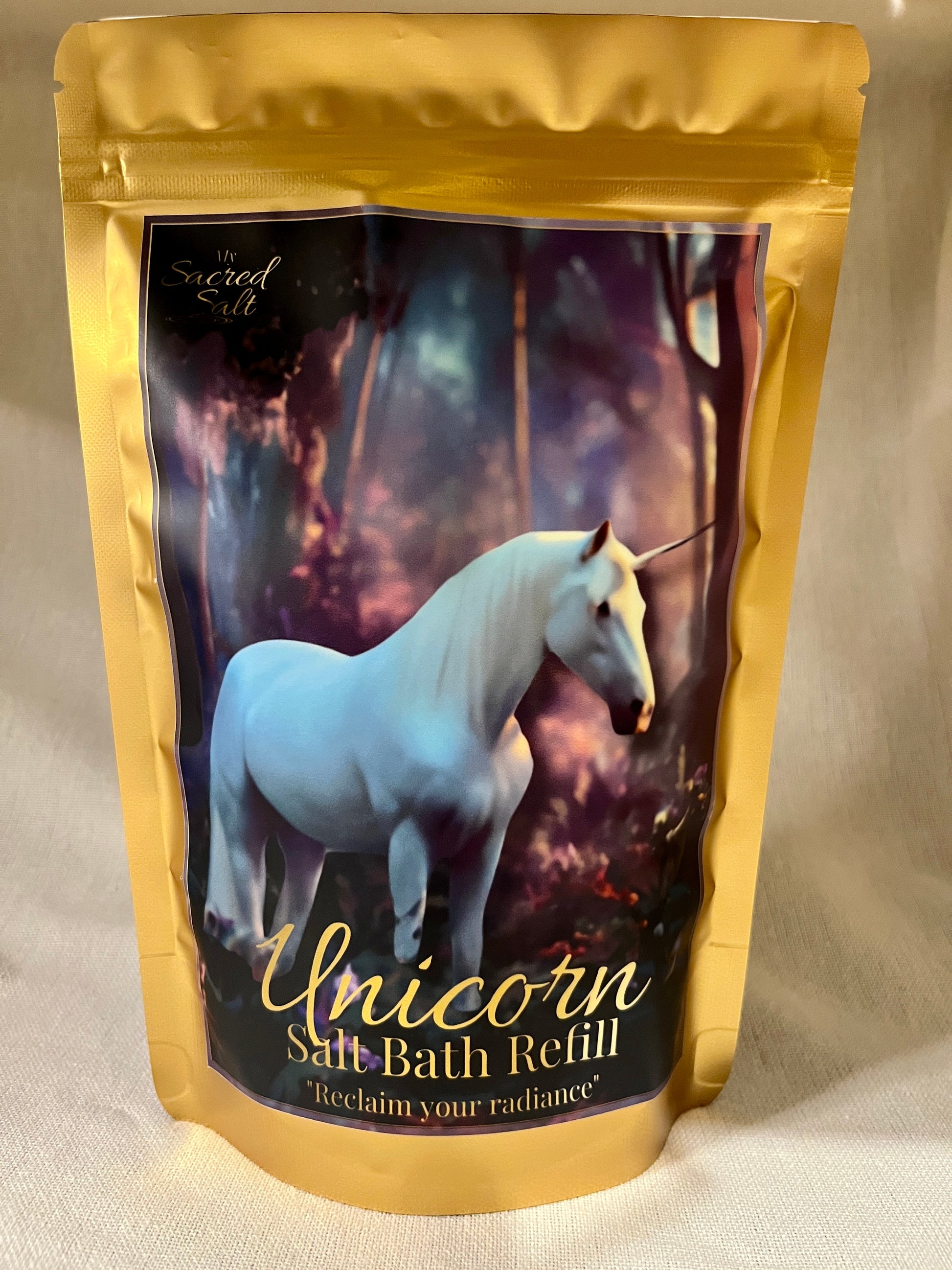 Unicorn salt bath refill package with a white unicorn on a dark background